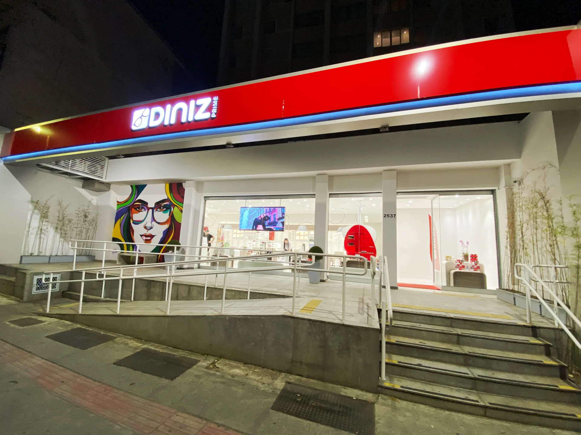 Fachada comercial com letreiro luminoso vermelho